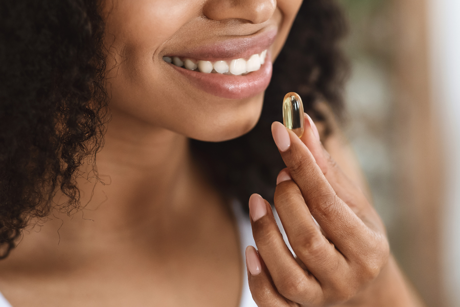 Woman taking omega 3 supplement for perimenopause